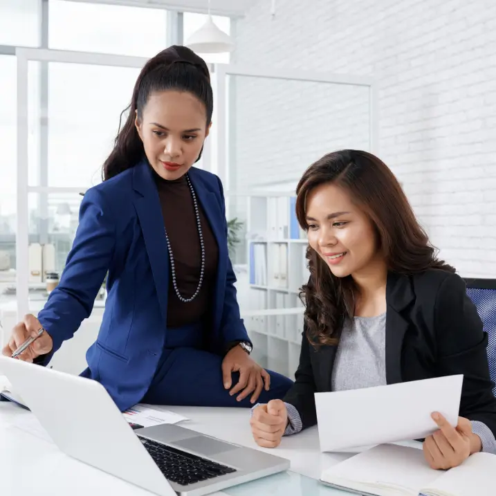 GeoVentures consultant walking a client through a financial report in Dubai